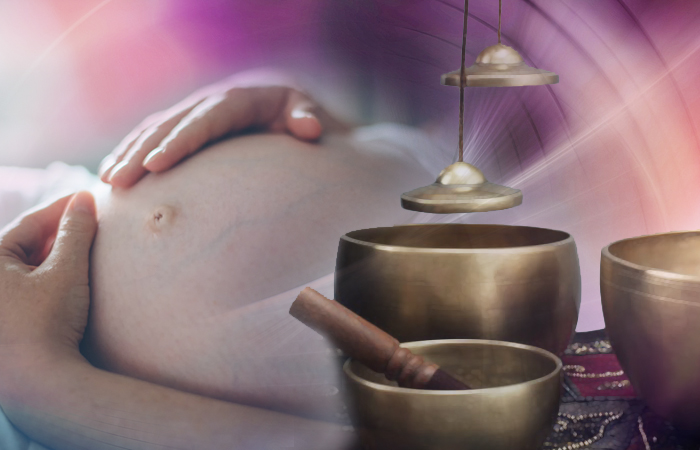 Tibetan singing bowls near a pregnant belly.